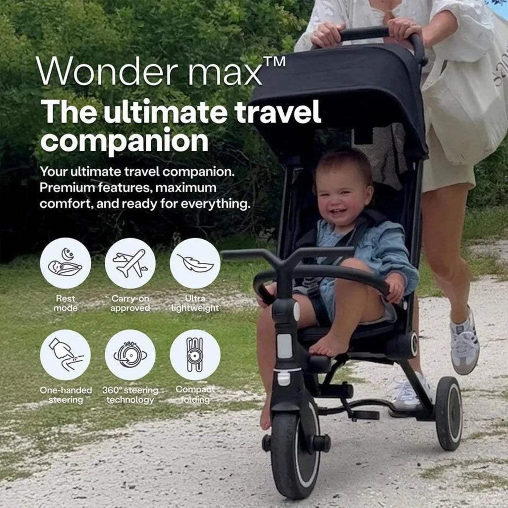 Jet black stroller trike with canopy and safety bar, child seated in front