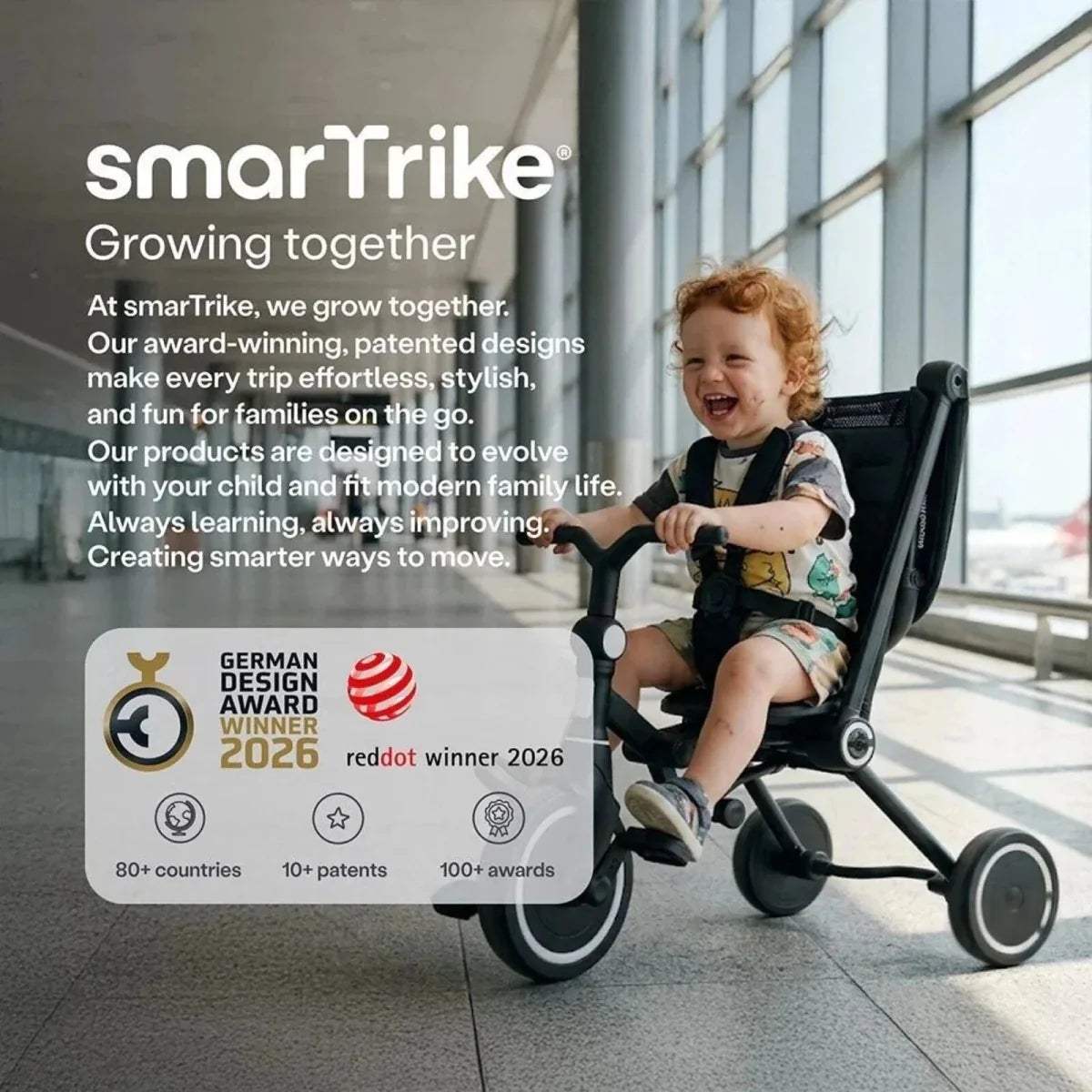Jet black stroller trike with child seated, large canopy and front wheels