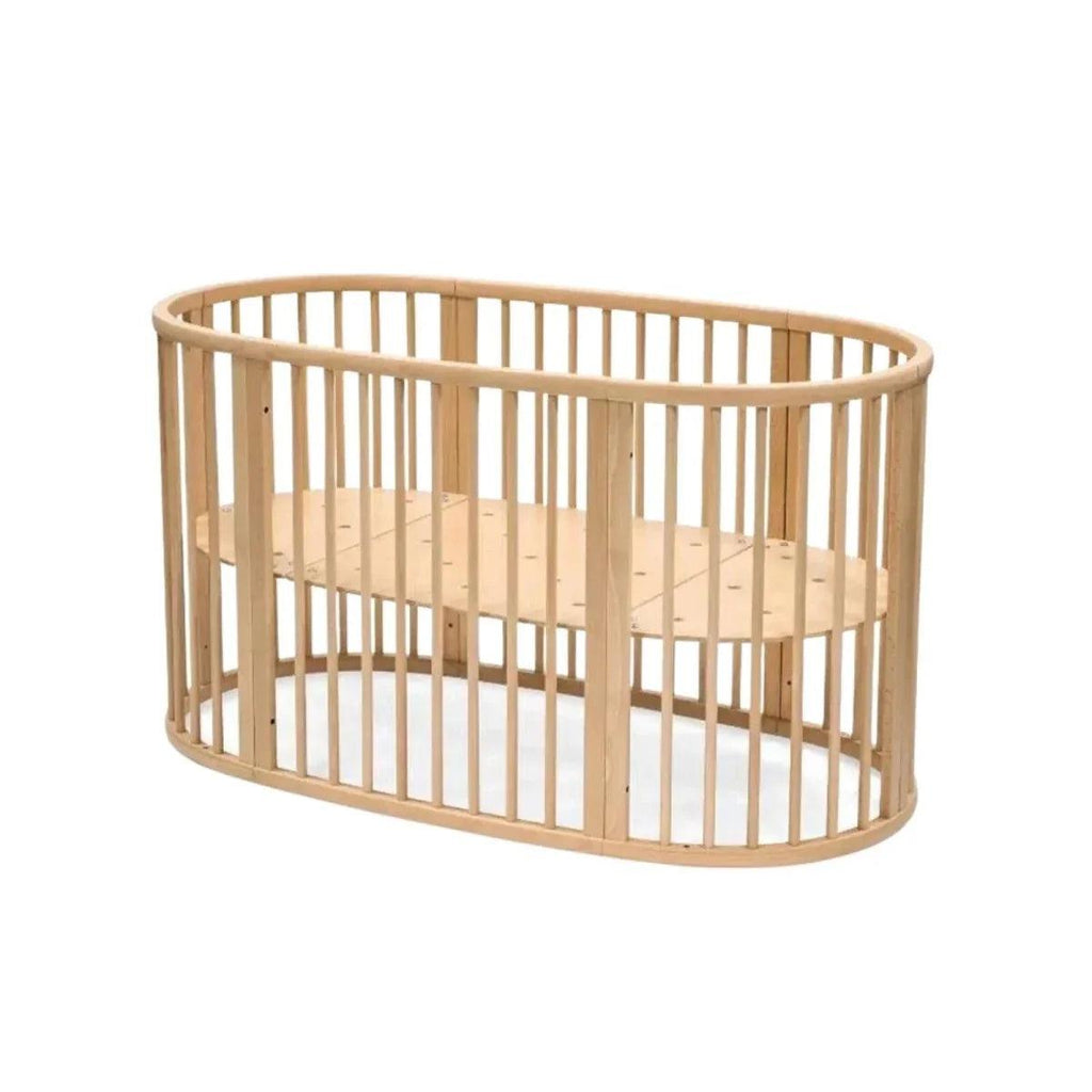 Natural wood oval baby crib with vertical slat rails and rounded end panels