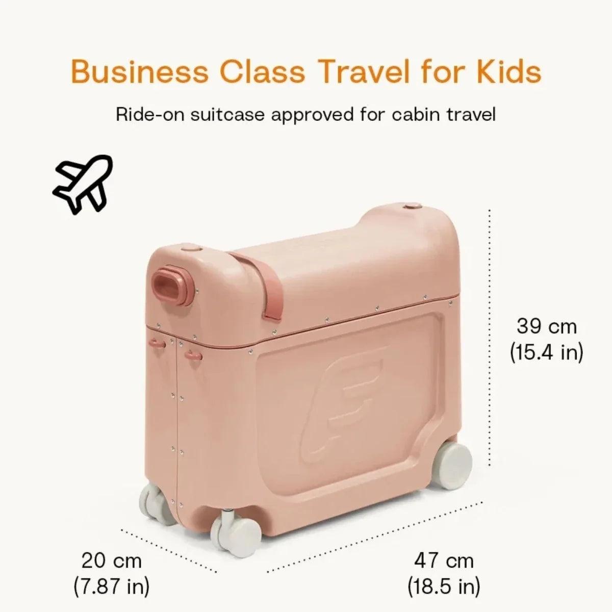 Coral pink kids BedBox ride-on suitcase with handle and large wheels in travel setting