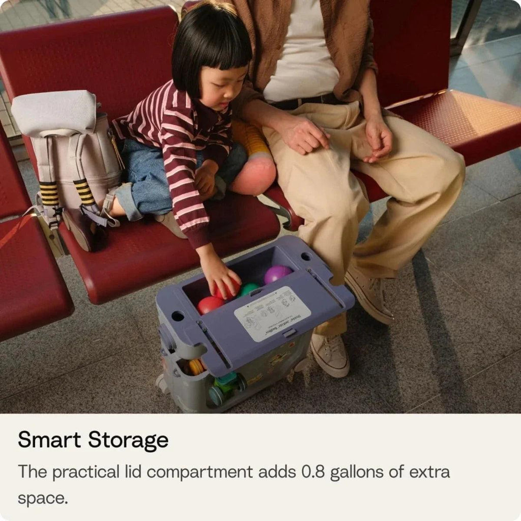 Kids travel bedbox with lid open, revealing storage compartment and toys inside