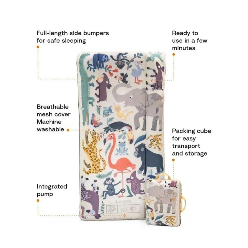 Kids travel bed with animal print cover, full-length side bumpers, and packing cube