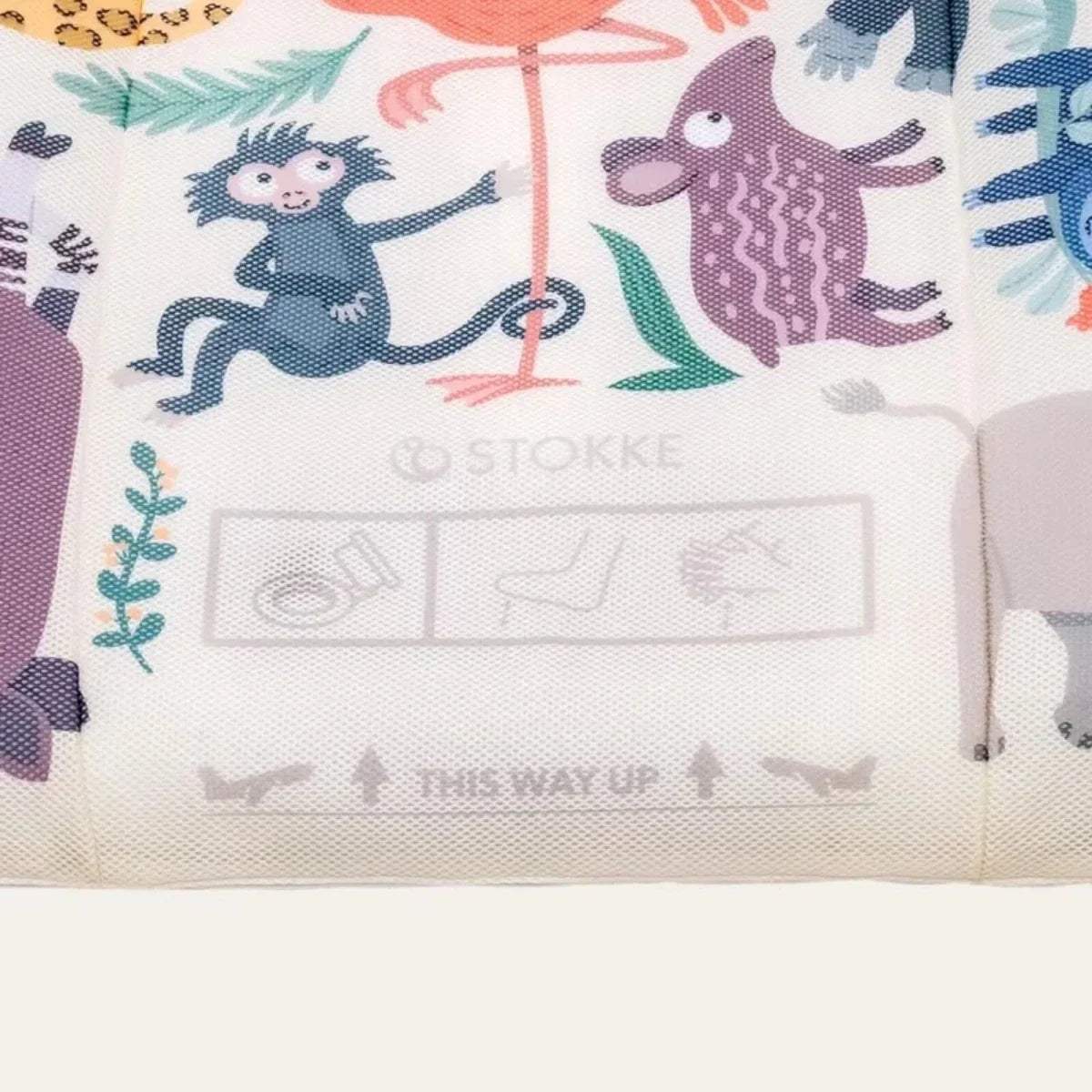 Animal print side mesh panel with safety icon label on kids travel bed