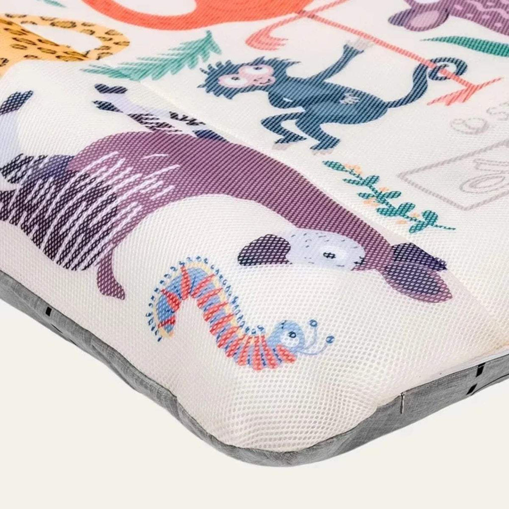 Corner view of animal print kids travel bed cover with padded gray edge