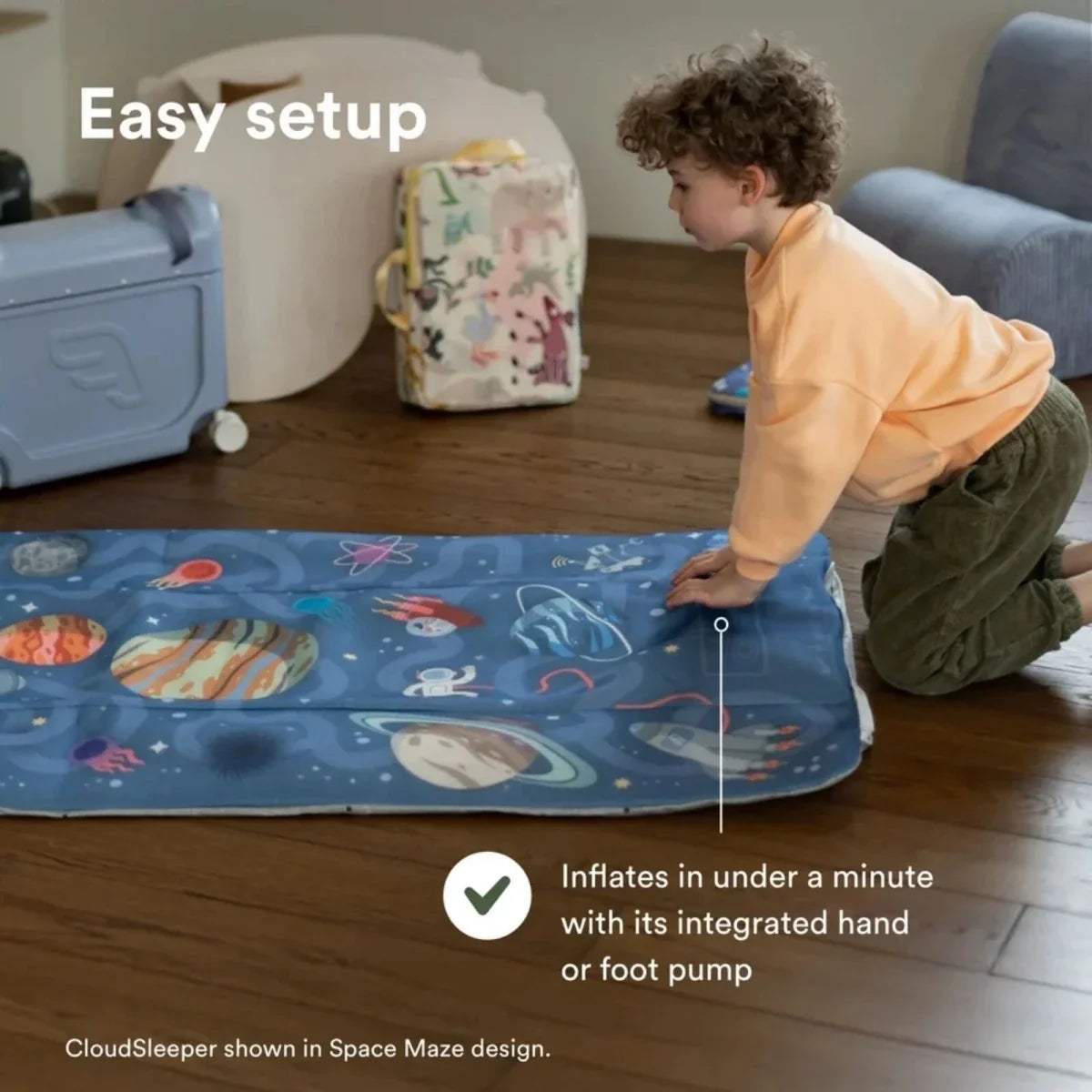 Child adjusting an animal print inflatable kids travel bed on the floor