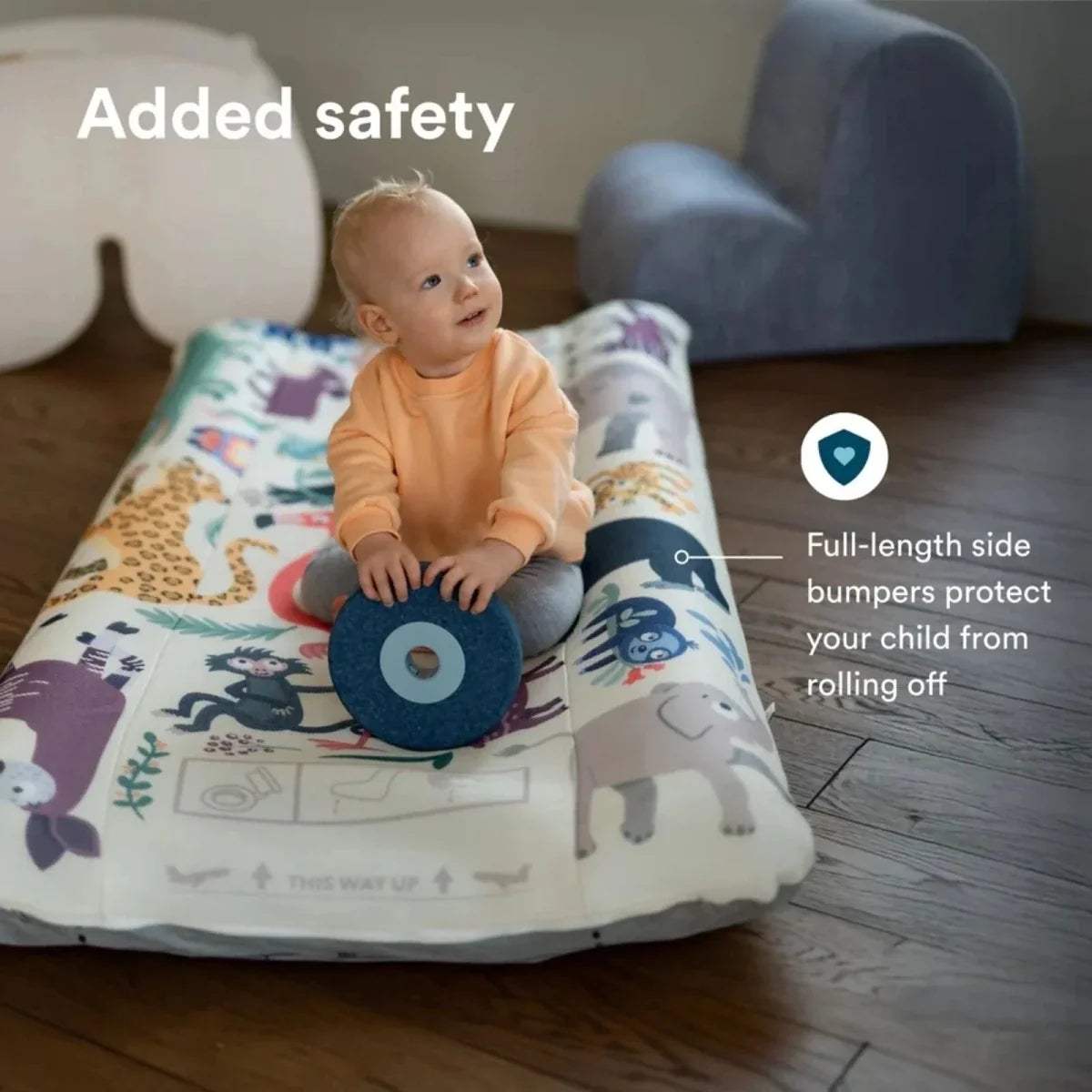 Stokke Jetkids CloudSleeper travel bed with blue side bumper and animal space print