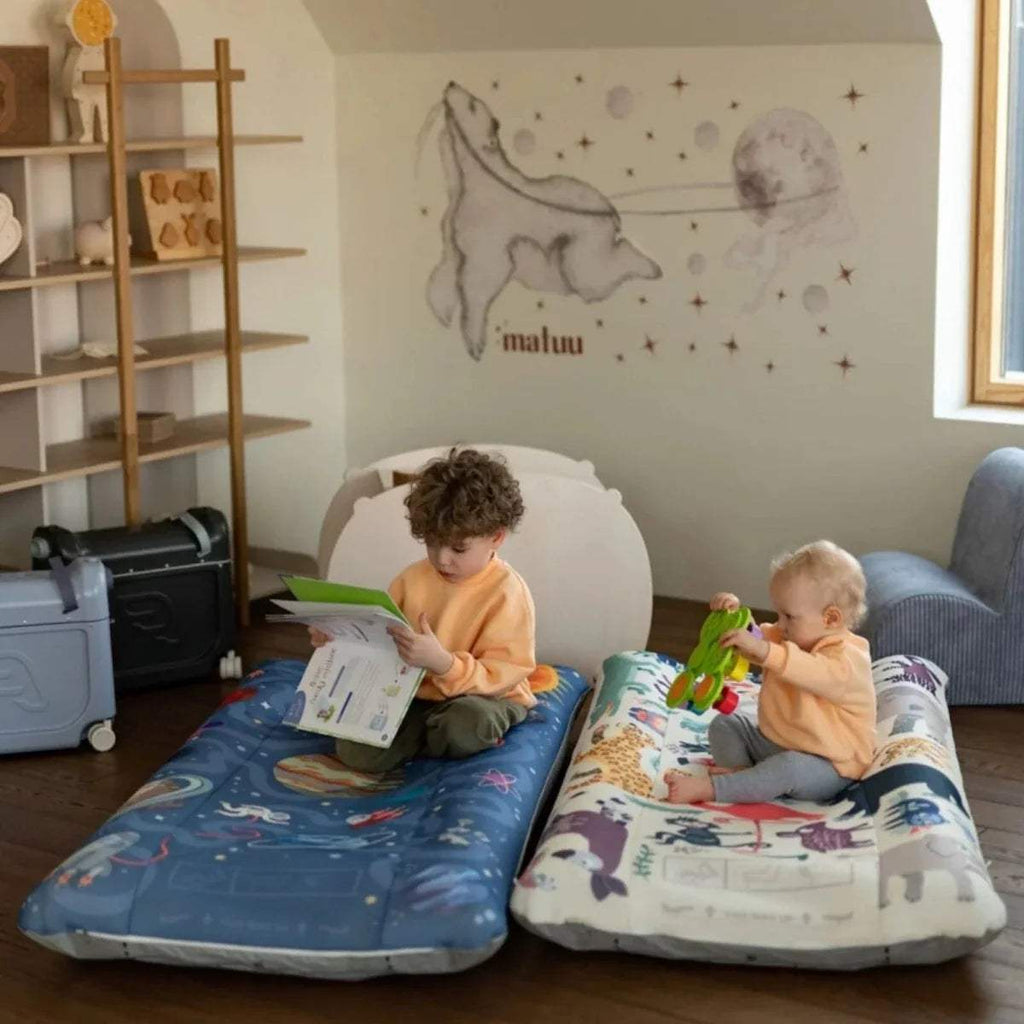 Stokke Jetkids CloudSleeper travel bed with two blue patterned sleeping surfaces