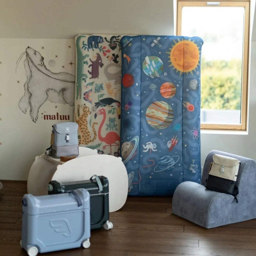 Stokke Jetkids CloudSleeper travel bed with blue space-and-animals outer fabric