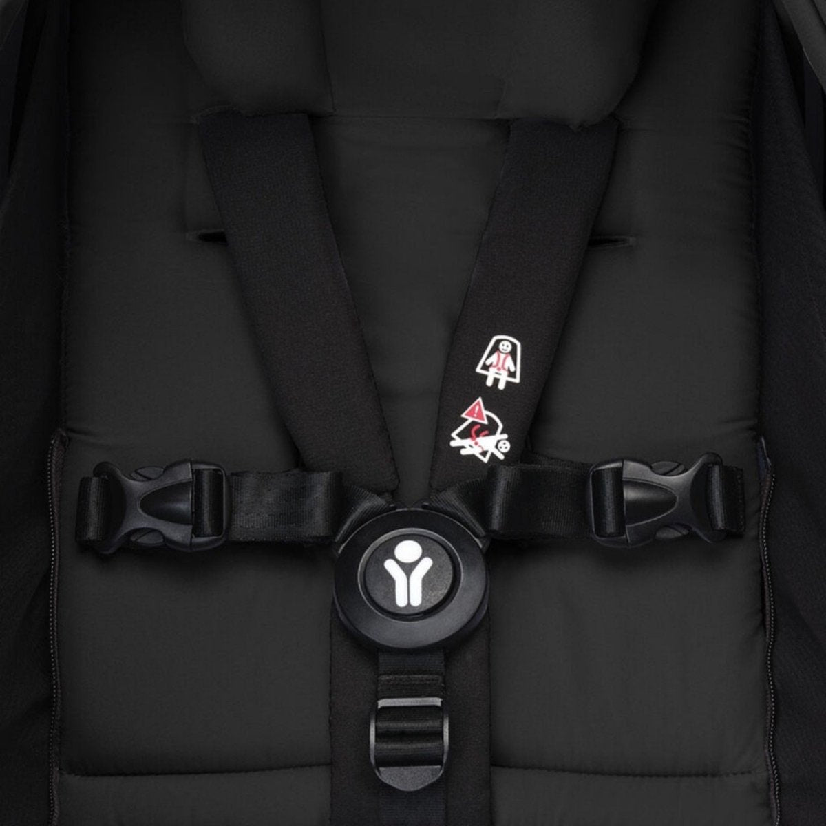 Black newborn harness with padded straps and central buckle clip