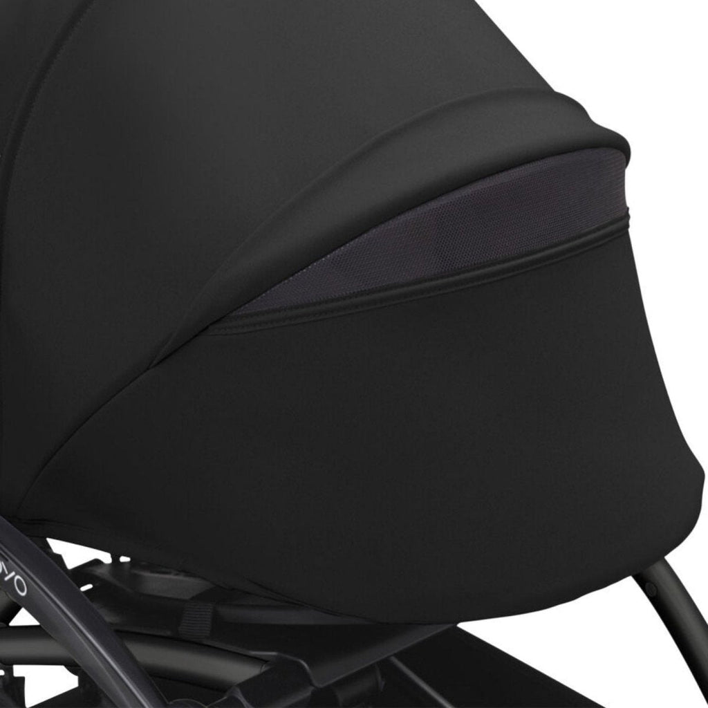 Black stroller side panel with zip seam detail along the edge