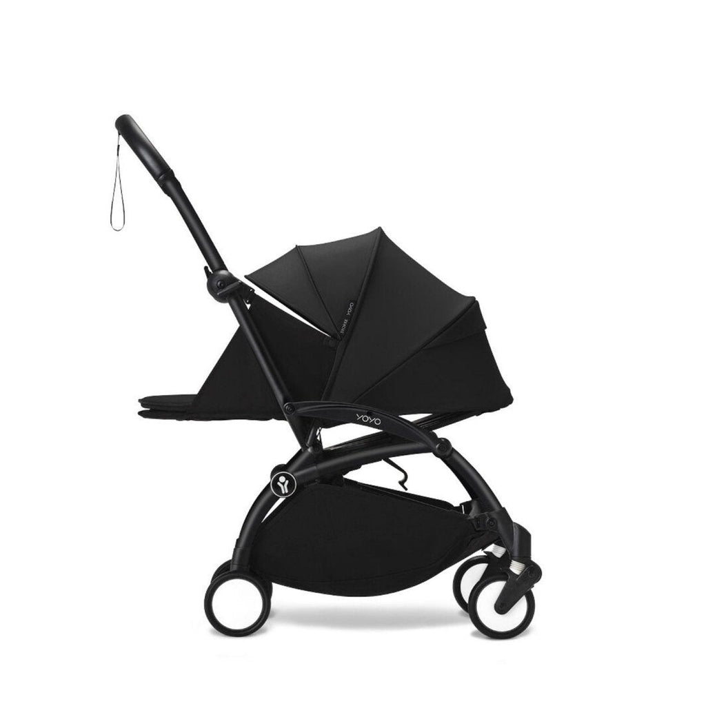 Black newborn stroller with canopy and compact fold frame