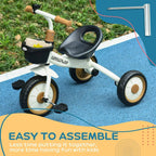 White kids tricycle with black basket and EVA tires on a paved outdoor path