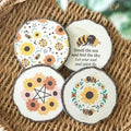 Round wood slice coasters set with bee and sunflower prints, four-piece grouping