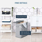 Grey laundry basket with flip lid open and side handles, removable inner liner.