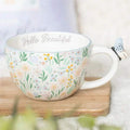 White mug with pastel floral ditsy print, “Hello Beautiful” text, and butterfly handle charm