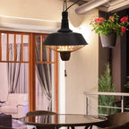Black hanging halogen patio heater under ceiling, glowing heating element