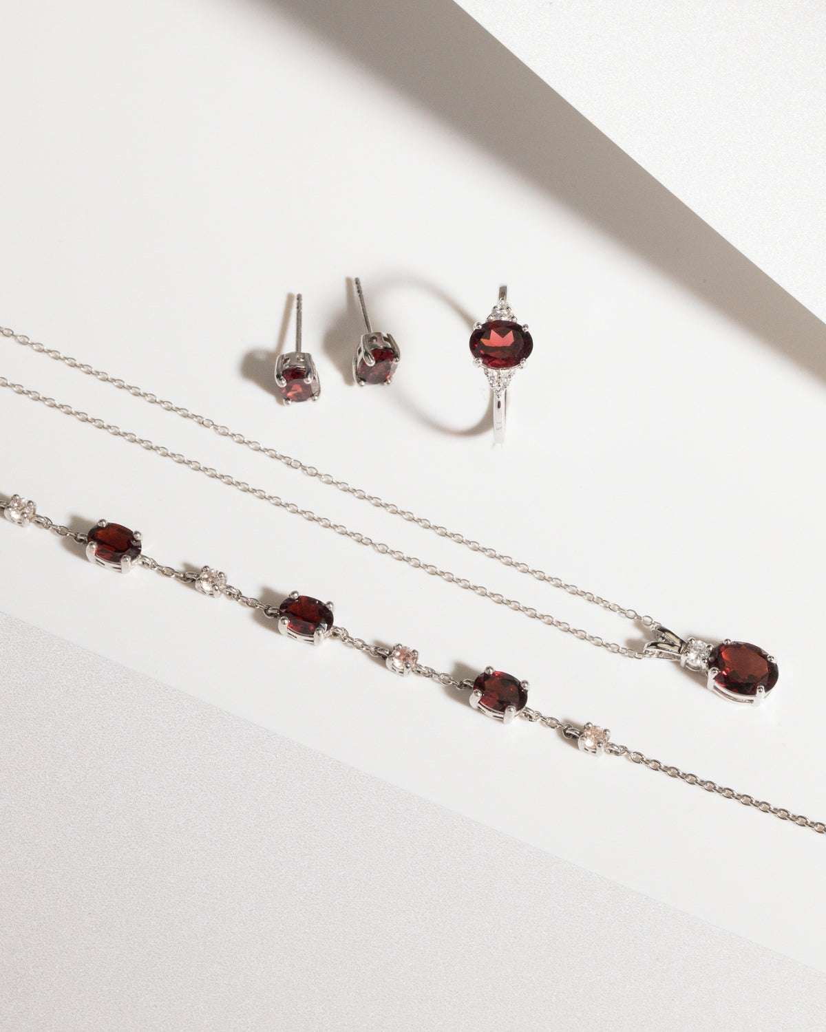 Sterling silver garnet necklace, earrings, and ring set with red oval stones