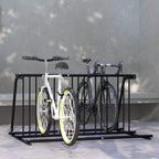 Black bike rack floor stand holding multiple bicycles between two rows of bars
