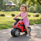 Toddler riding red and black balance bike with handlebar and wide tires