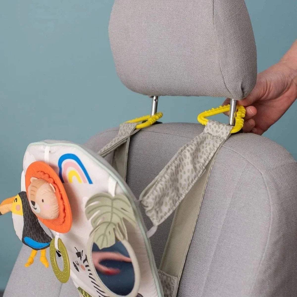 Baby play & kick activity car toy secured to seat with lion ring and leaf-texture details