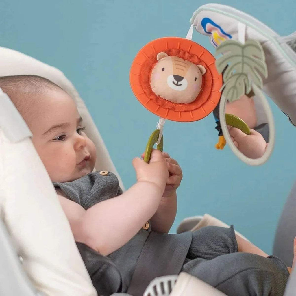 Lion face bell ring toy on baby play & kick activity car, shown with rainbow and leaf mirror