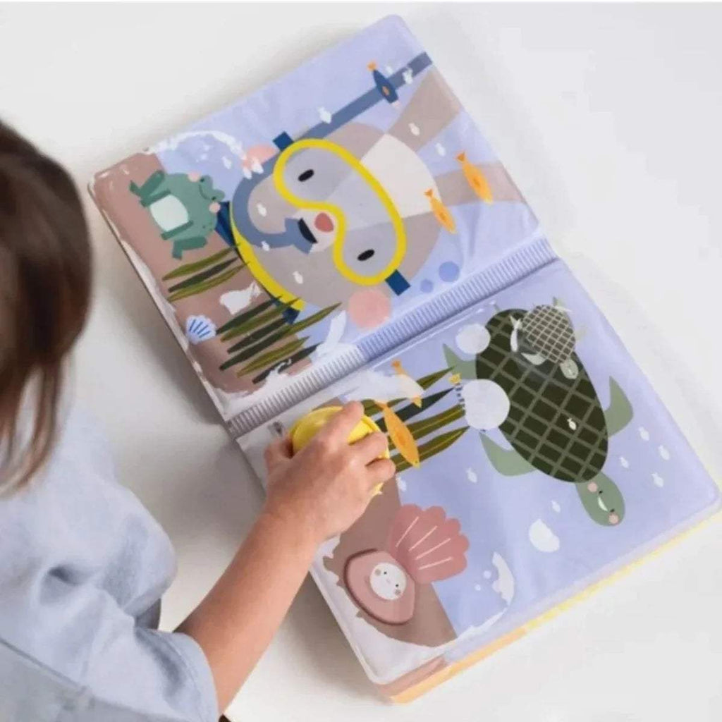 Kids using a yellow magic stamp on a peek-a-boo water book page