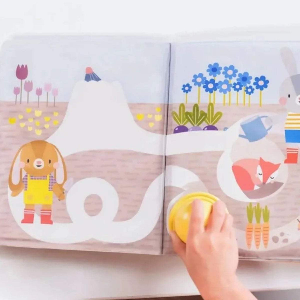 Open peek-a-boo water book with farm scenes and rabbit characters; stamp included