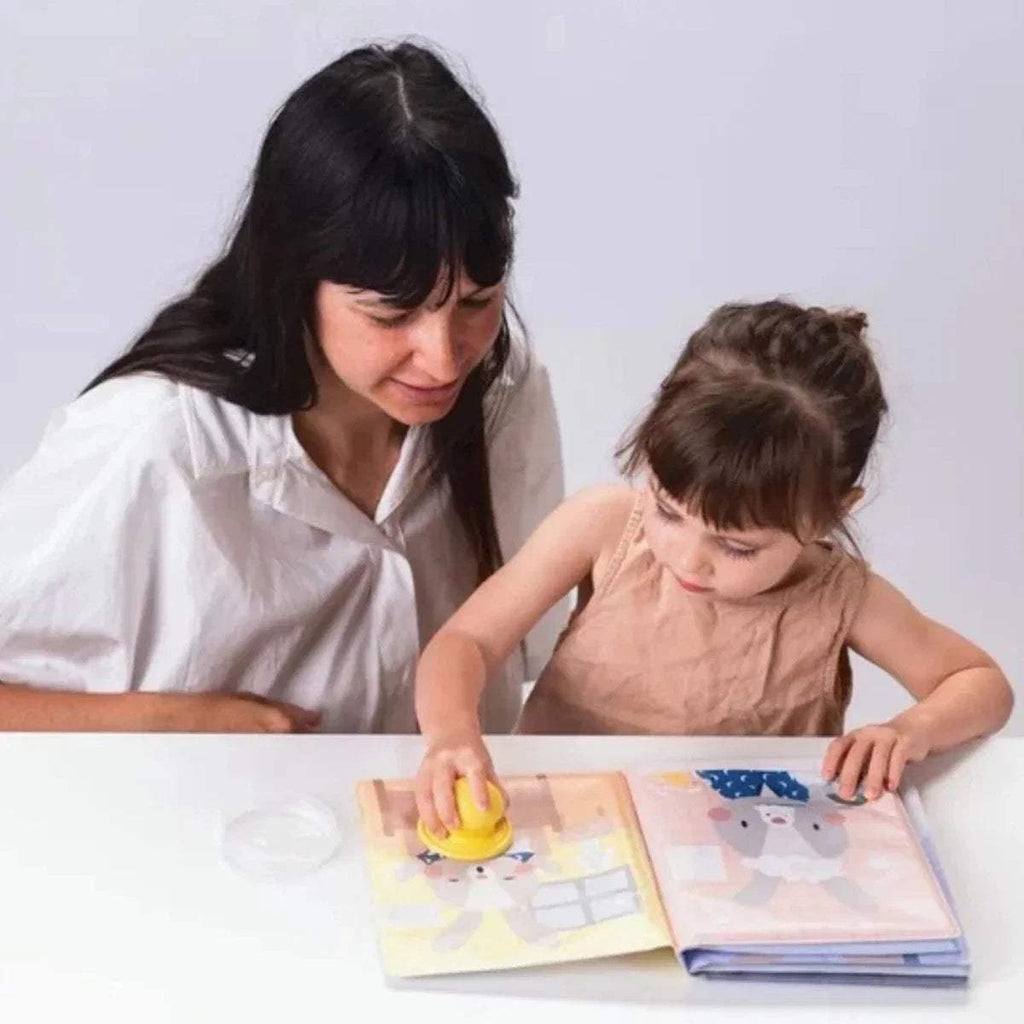 Children's water book with colorful pages and magic stamp, shown open
