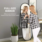 Black two-way curved full-length oval mirror standing upright with rounded top frame.