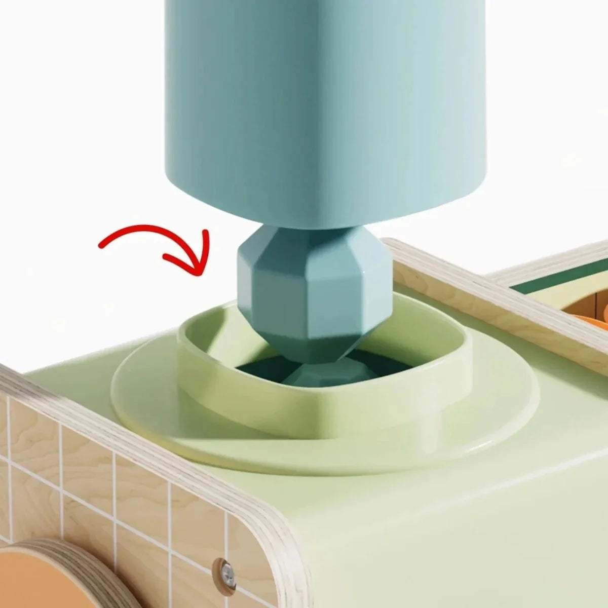 Teal ice cream machine dispenser nozzle over green base, close-up