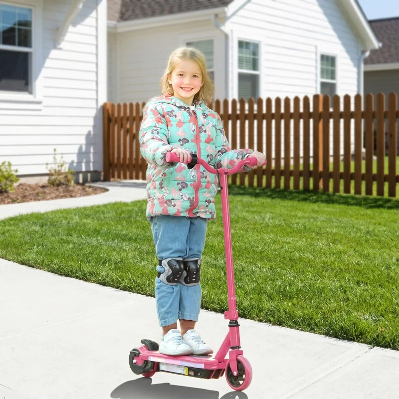 Pink electric kids scooter with rider standing on the deck and front wheel