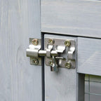 Close-up of light grey cat enclosure door latch and metal locking hardware.