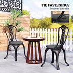 Four dark grey round seat cushions with ties on outdoor dining chairs