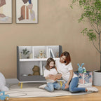 Grey and white two-tier storage shelf with five compartments beside children playing
