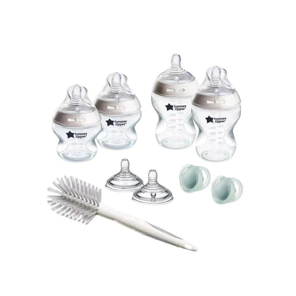 Baby bottle starter kit with four clear bottles, two caps, two teats, and cleaning brush