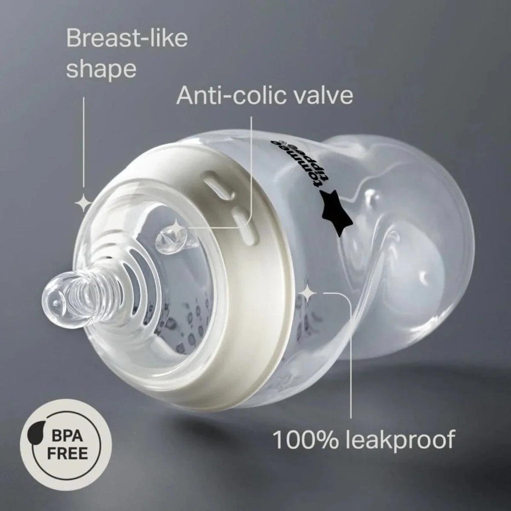 Close-up of clear baby bottle with white anti-colic valve insert and soft nipple