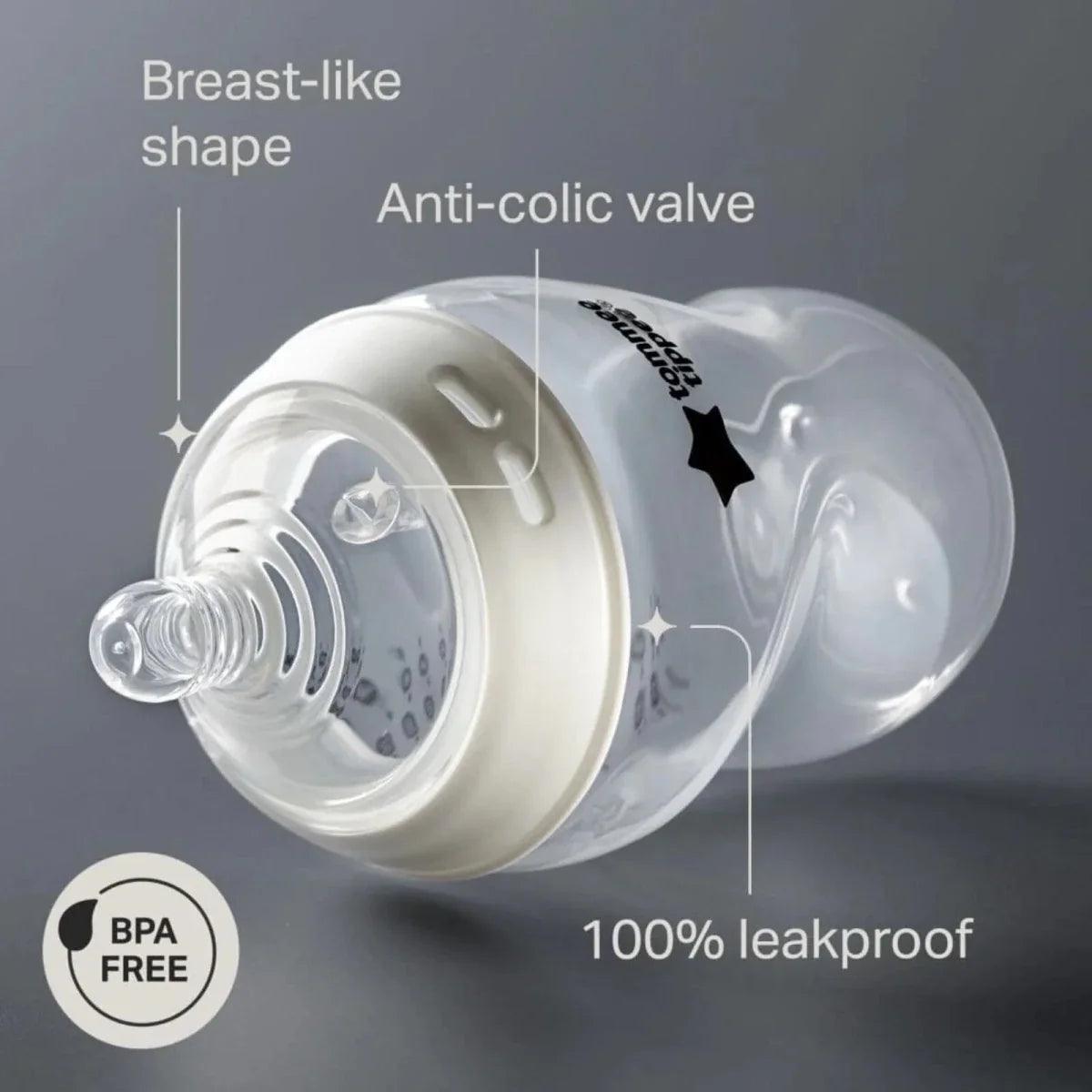 Close-up of clear baby bottle with white anti-colic valve insert and soft nipple