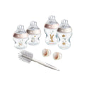 Pink newborn bottle starter kit set with bottles, cleaning brush, and spare caps