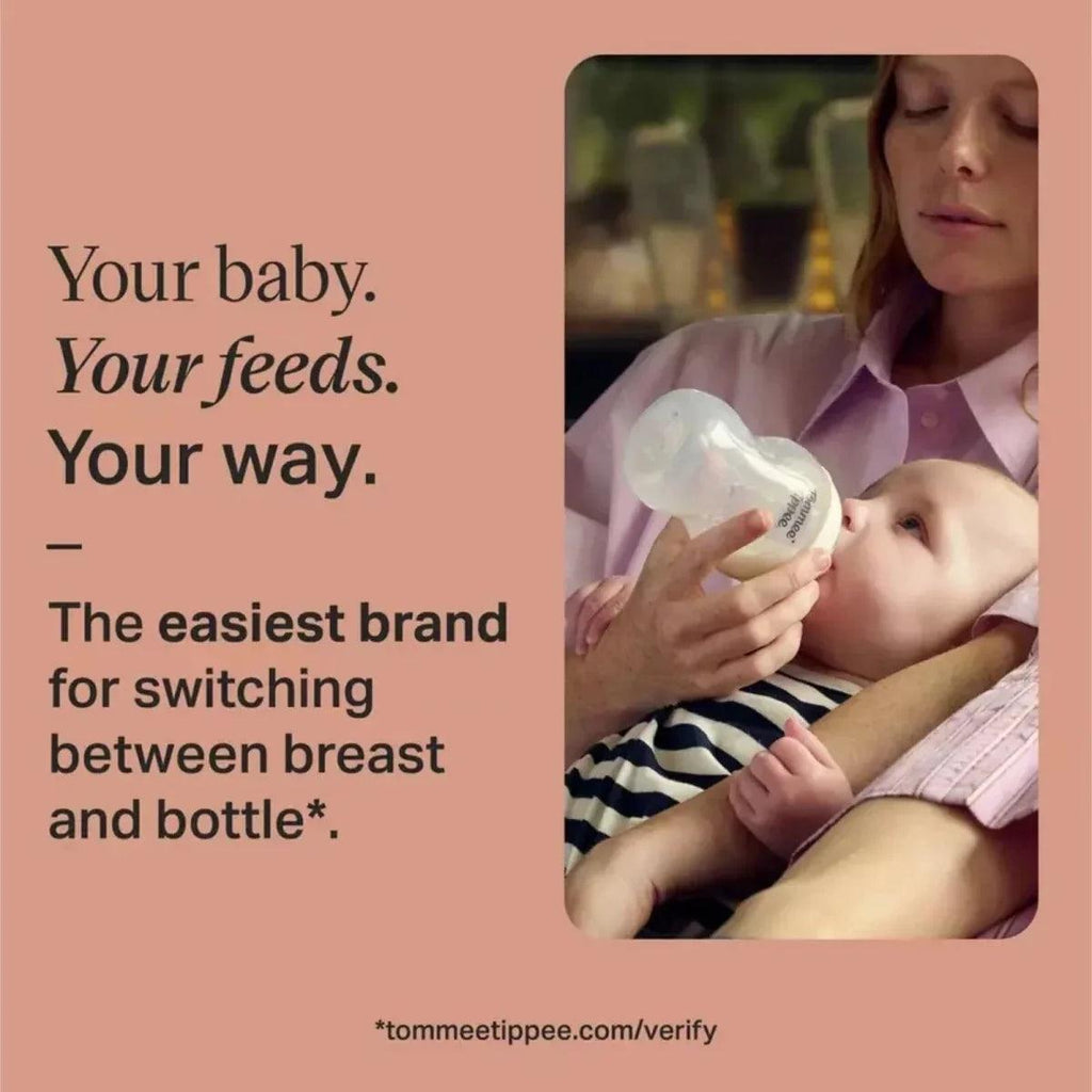 Adult holding a newborn feeding bottle while breastfeeding a baby