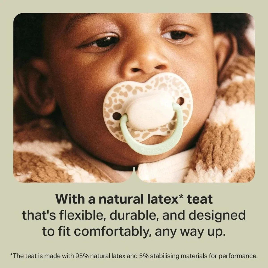 Latex soother with cream teat and pale green shield held in place.