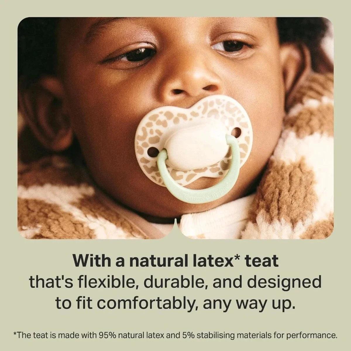 Latex soother with cream teat and pale green shield held in place.