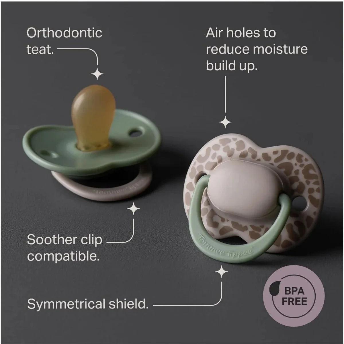 Two orthodontic latex soothers with green shields; one cream leopard-style.