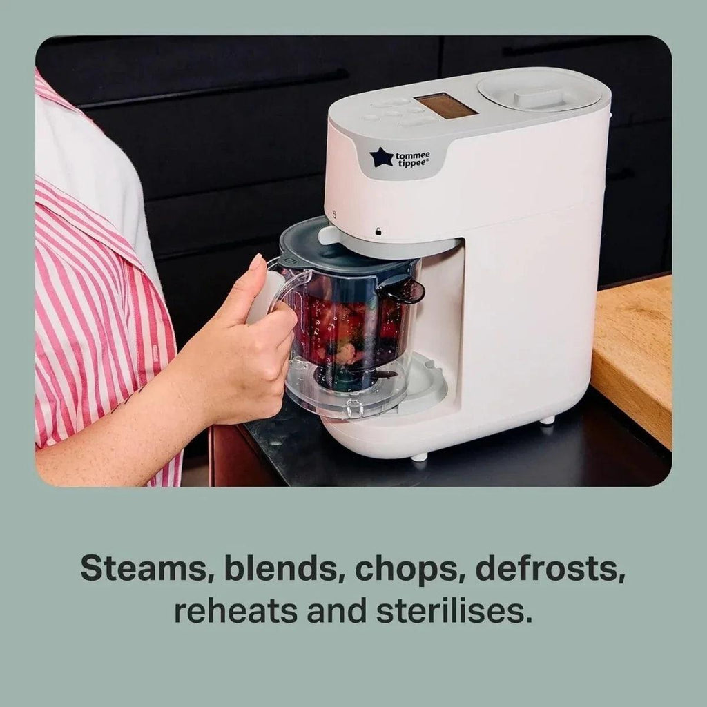 White baby food maker with clear jug on counter, lid and blending unit visible