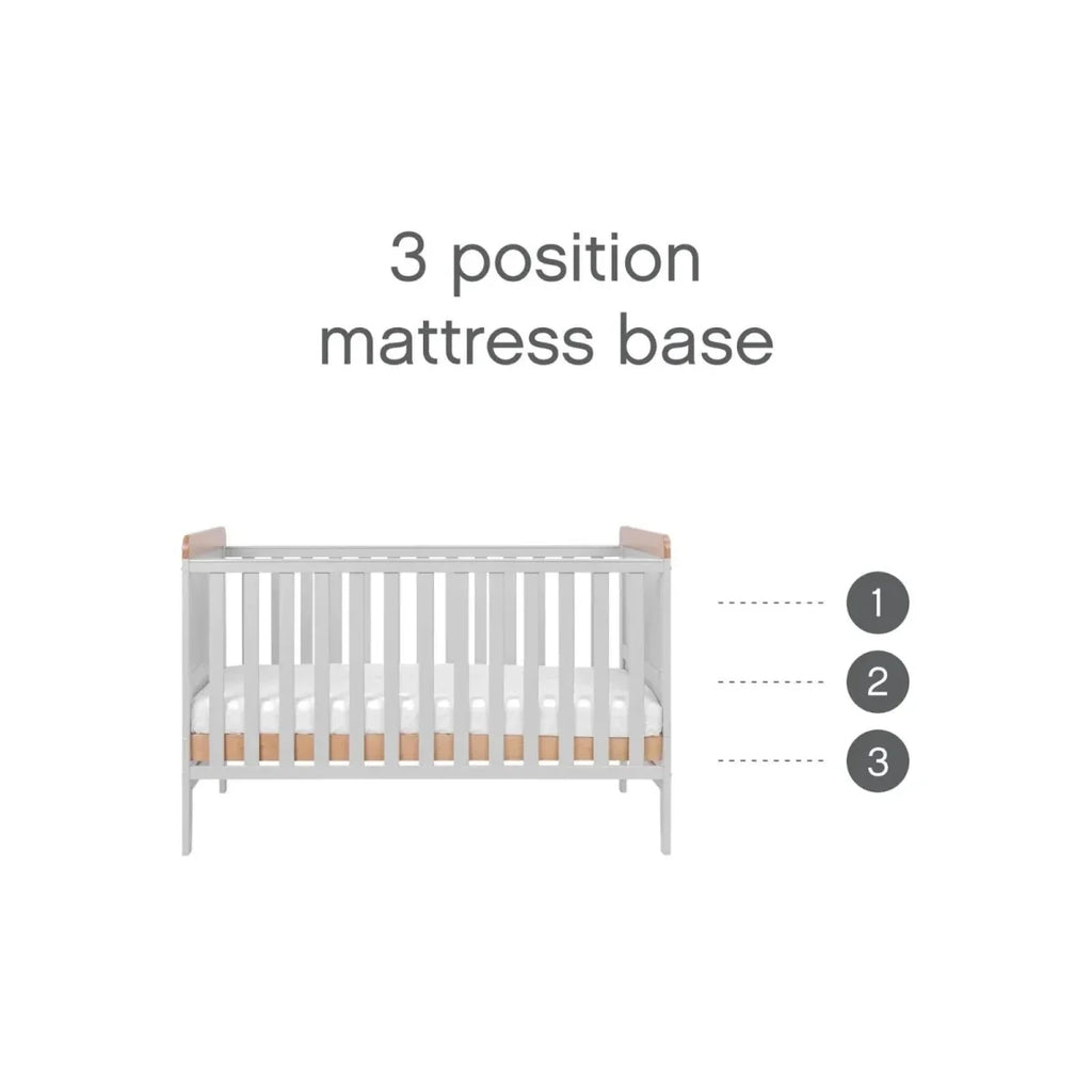 Cot bed with 3-position mattress base showing adjustable heights