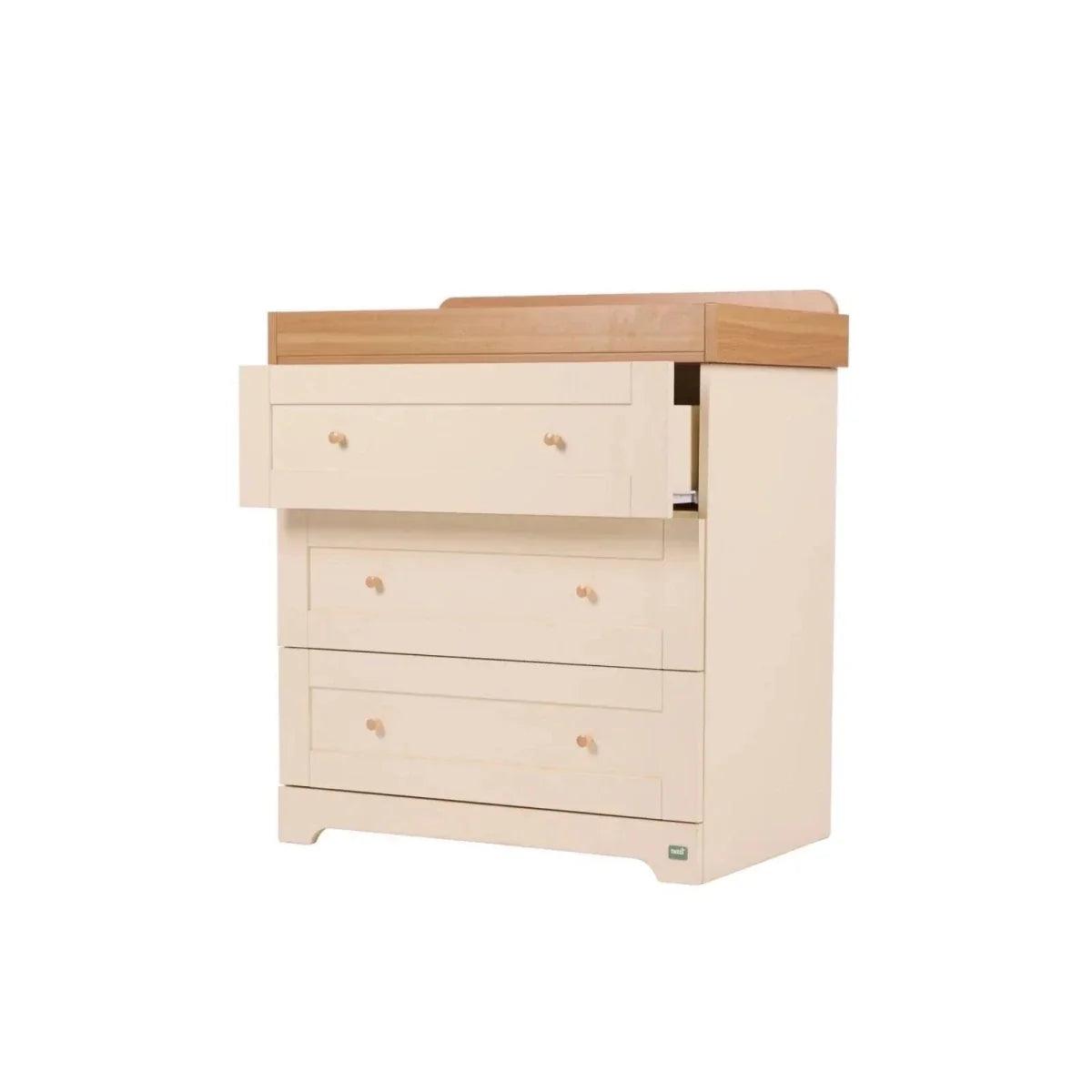 Cream cabinet dresser with honey oak top panel, four drawers and side panel detail