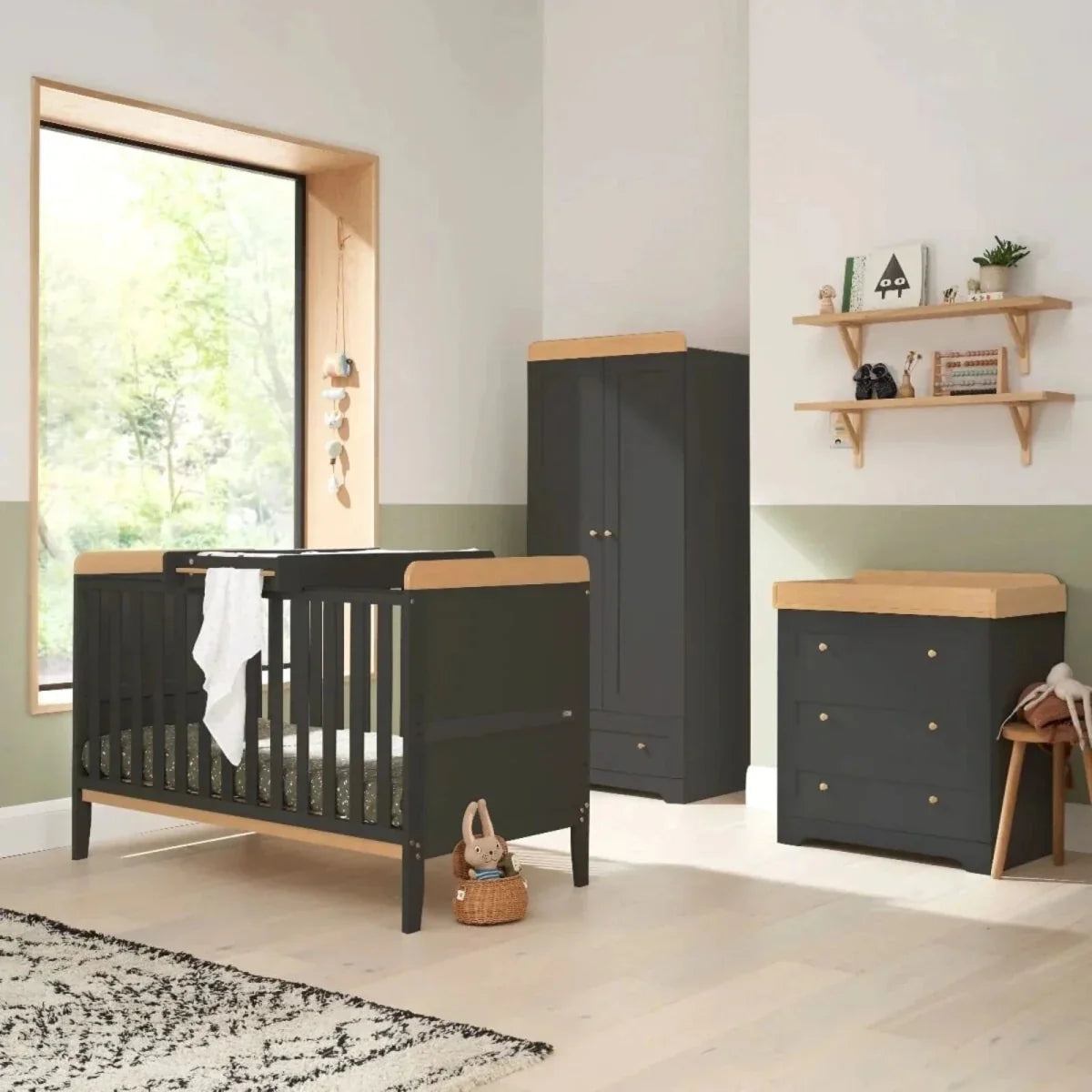 Dark slate cot bed with slatted sides and light wood mattress base, plus changing table