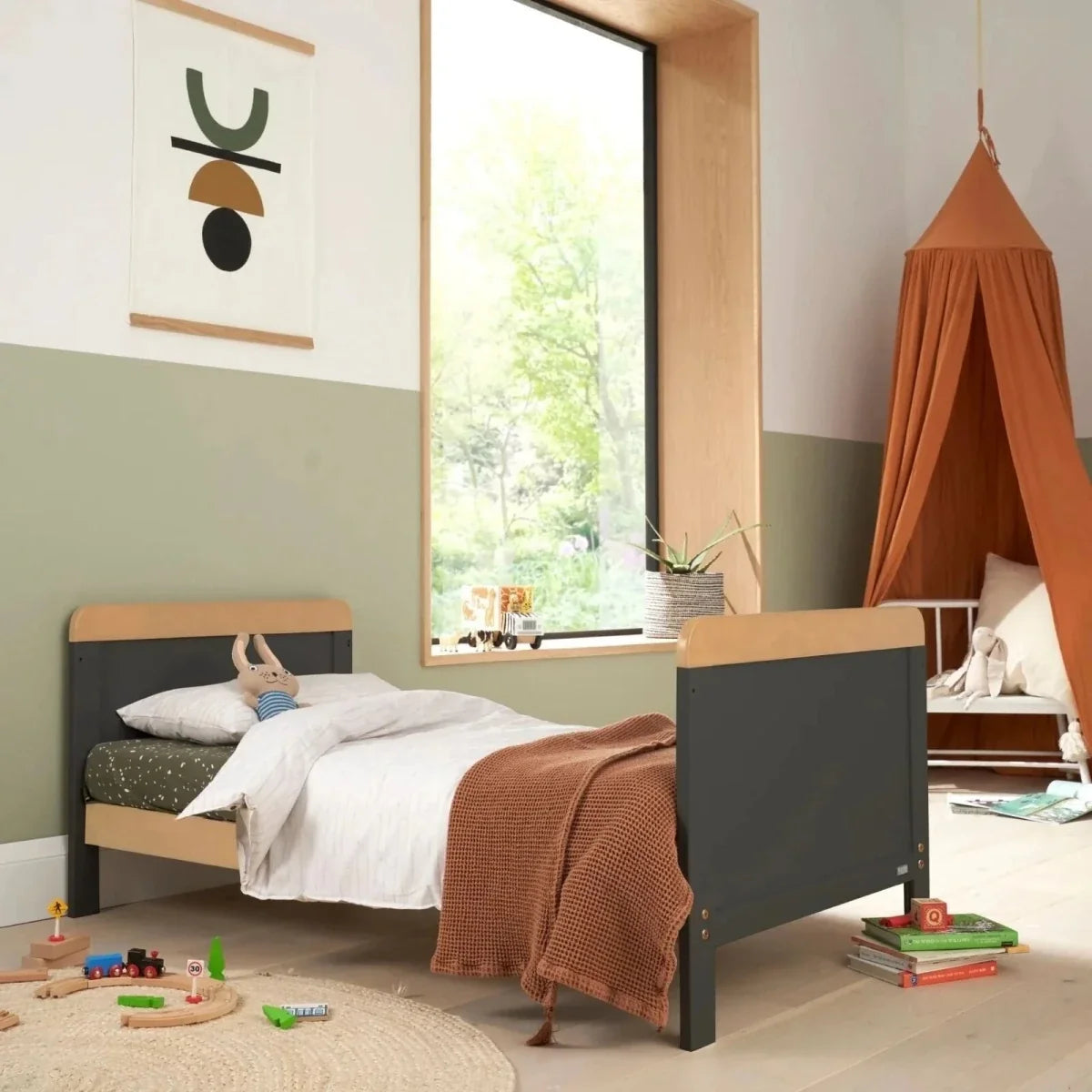 Slate toddler bed with light wood headboard and footboard, styled with bedding