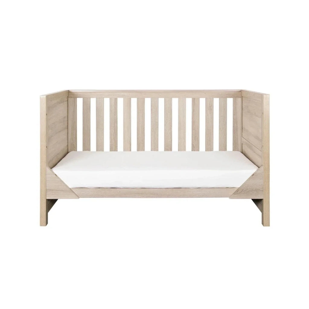 Oak toddler bed with slatted back and front panels, white mattress included