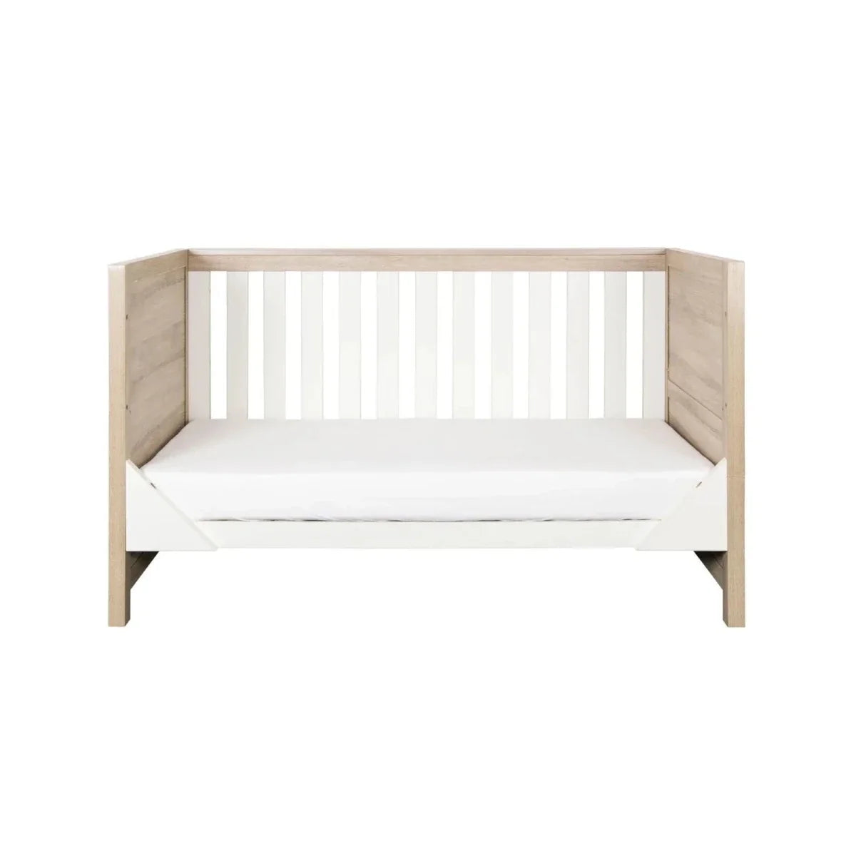 Children’s cot bed with white slatted headboard and matching light oak sides