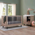 Distressed oak cot bed with slate-grey vertical bars and open mattress frame.
